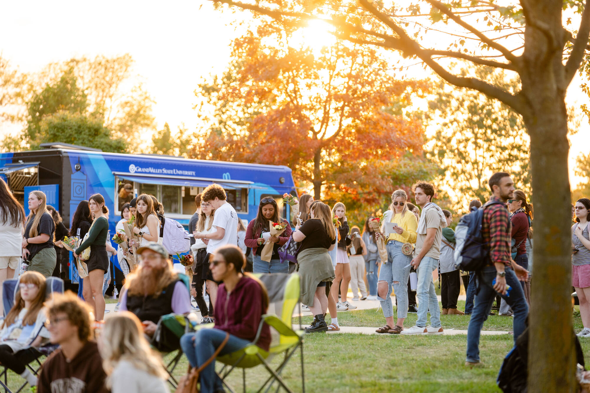 students gather in the GVSU Kirkhof Lawn to listen to a carillon concert